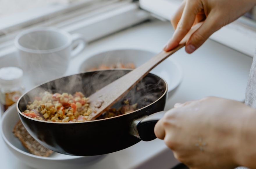 person holding black frying pan