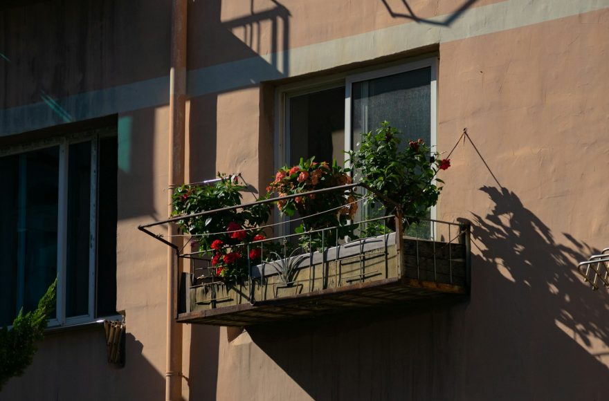 a balcony with a planter filled with flowers